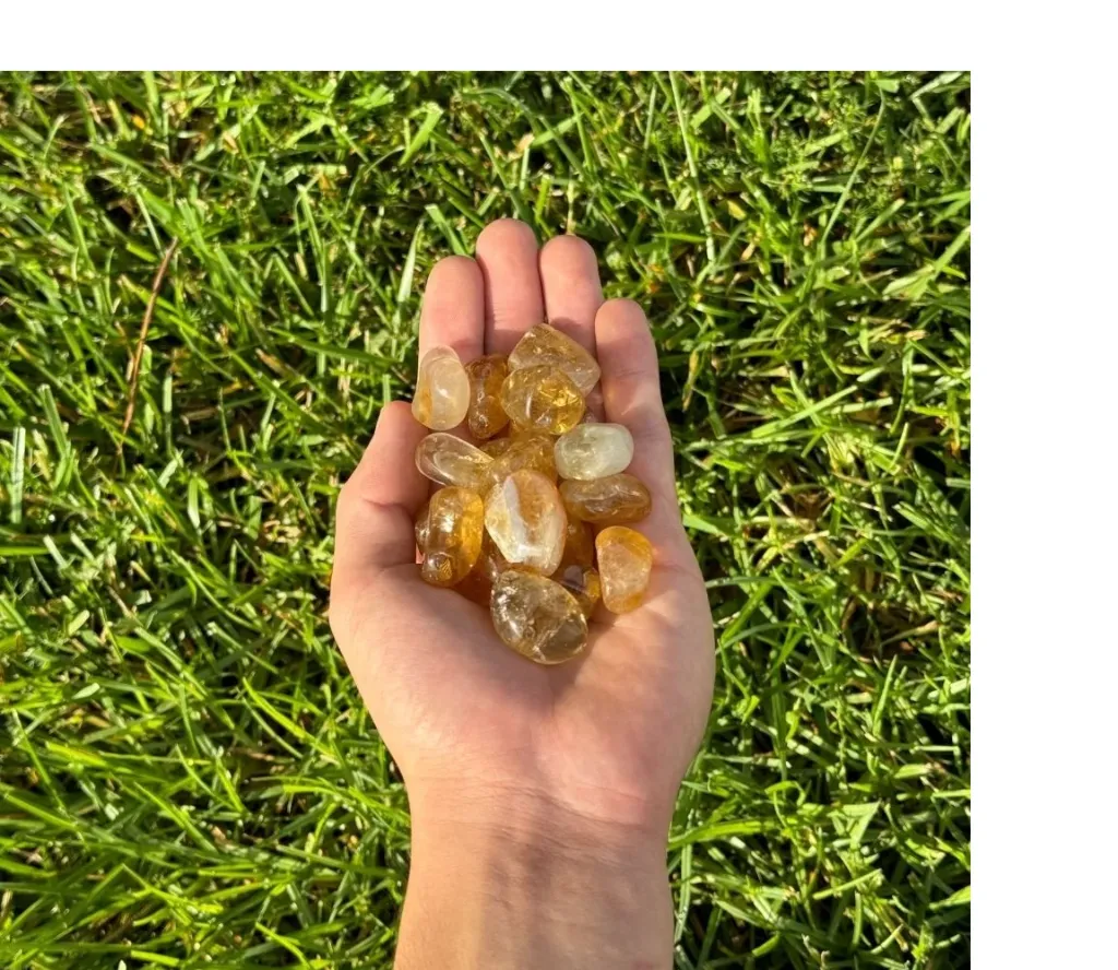 citrine tumbled stone held.webp